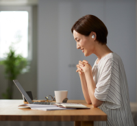 Woman viewing a laptop.